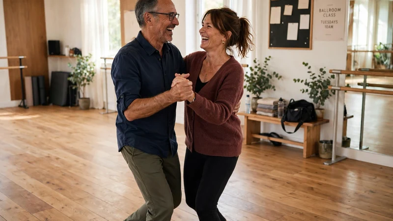Couple in their fifties laughing together during a ballroom dance class