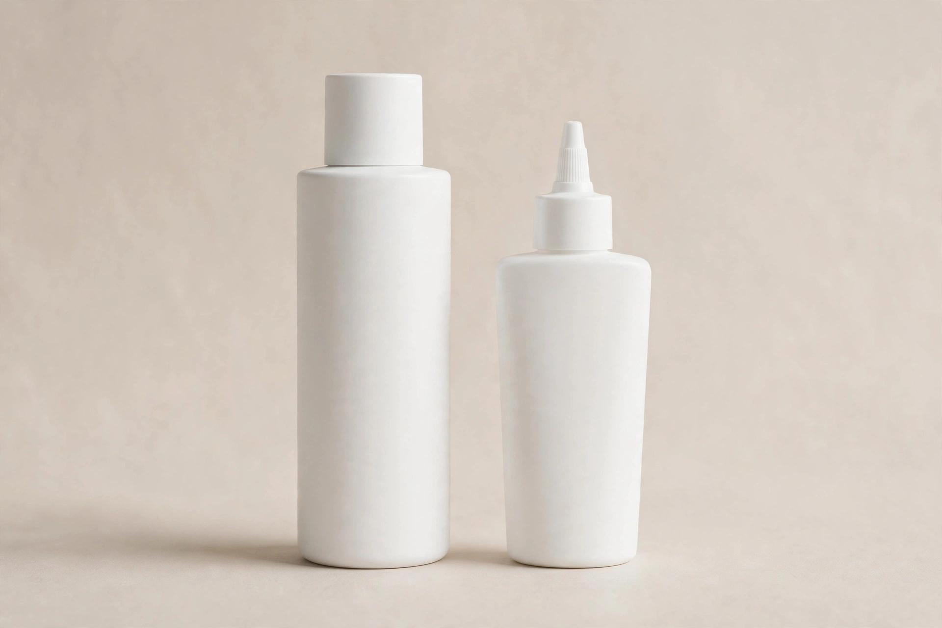 Two plain white feminine wellness bottles, representing a vaginal moisturizer vs lubricant comparison, on a soft beige background